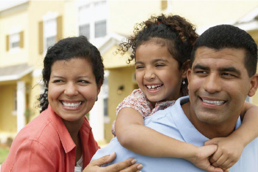 Woman, man, child smiling and looking into distance